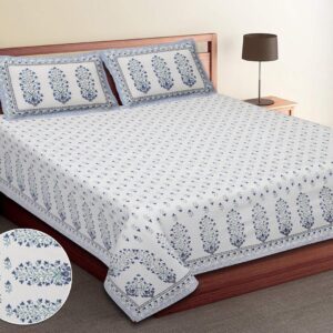 Top view of a neatly made double bed featuring a white bedsheet with a delicate blue floral block print pattern.